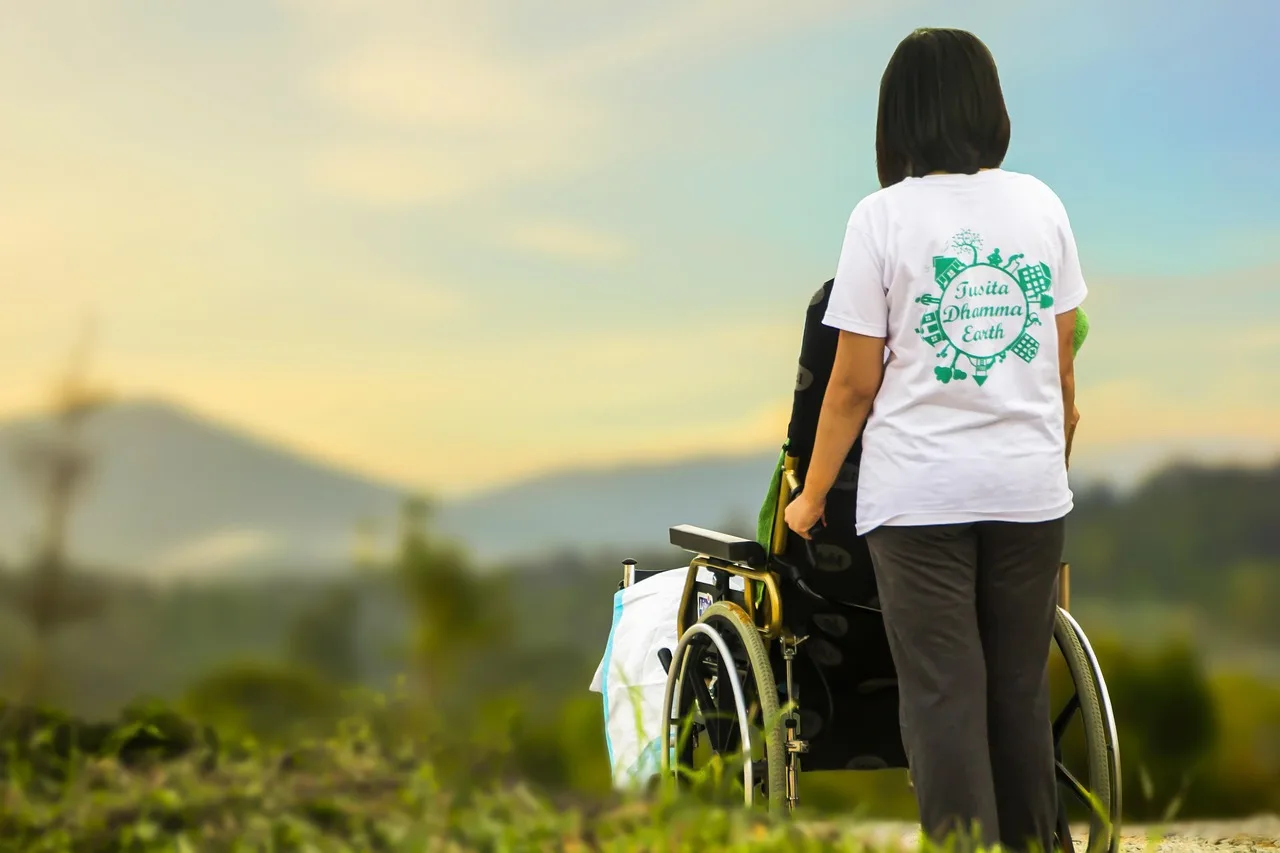 Nurse supporting an older adult patient as part of a chronic care program