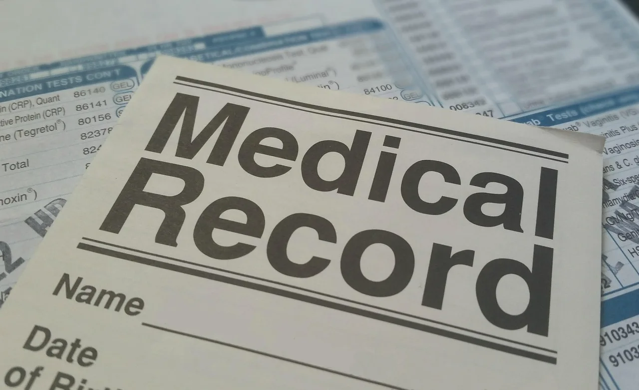 Patient signing a medical consent and notice form on a clipboard