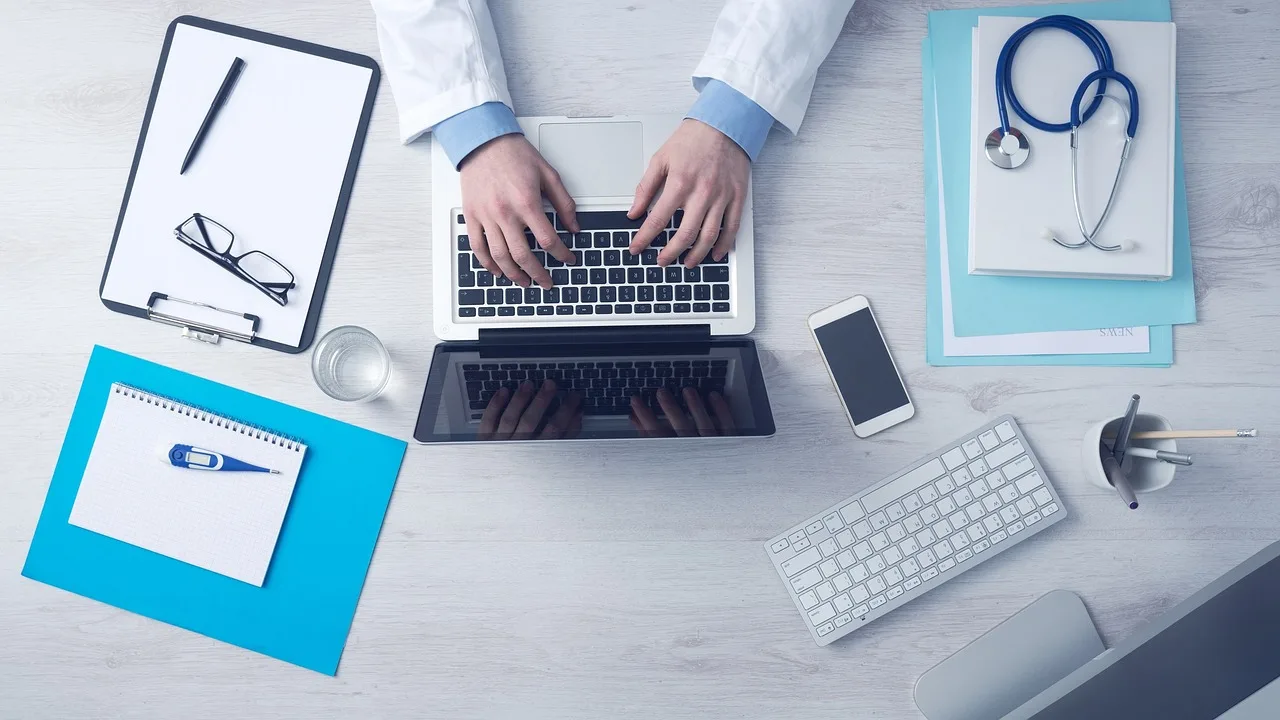 Physician conducting a video telehealth visit on a laptop